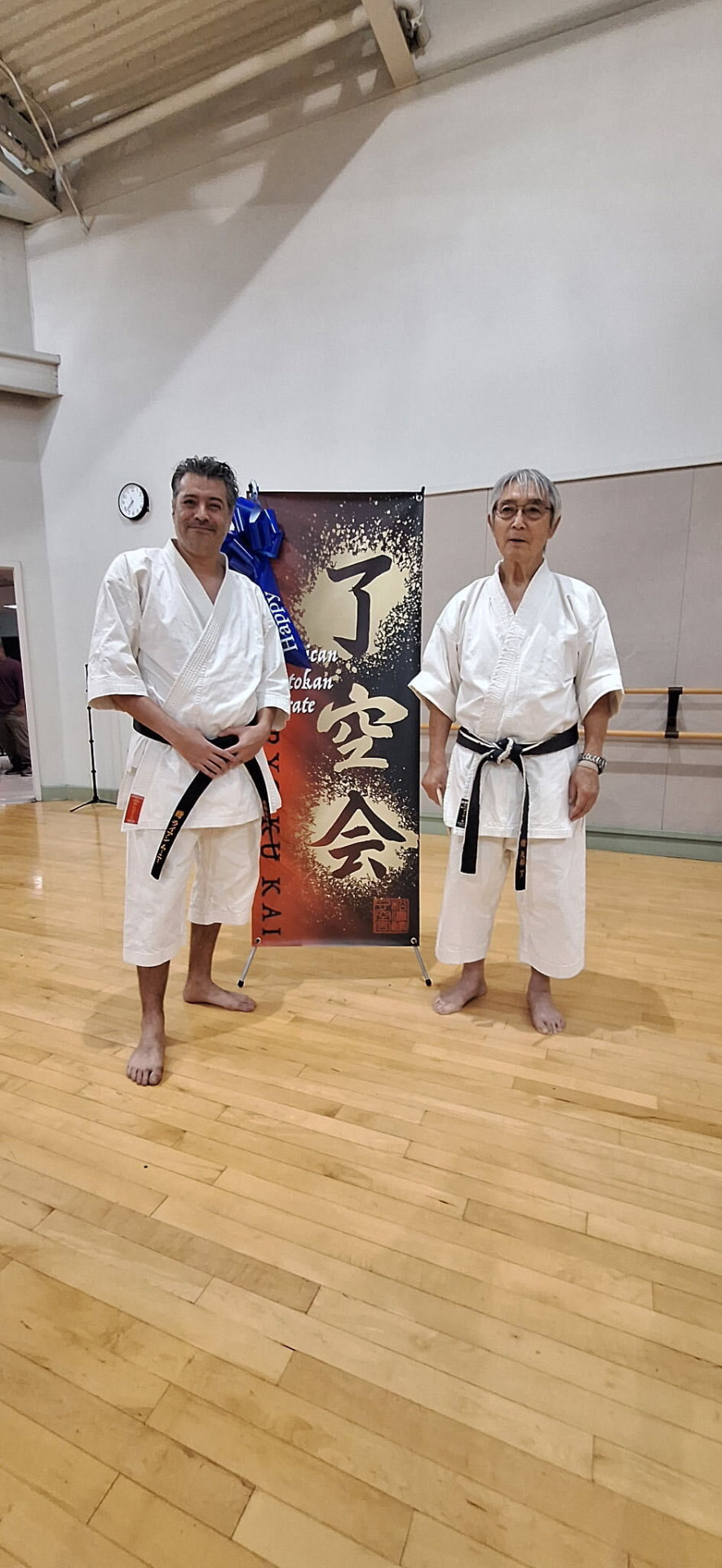 Sensei Ryan standing with Sensei James Yabe in the dojo after Shotokan karate training